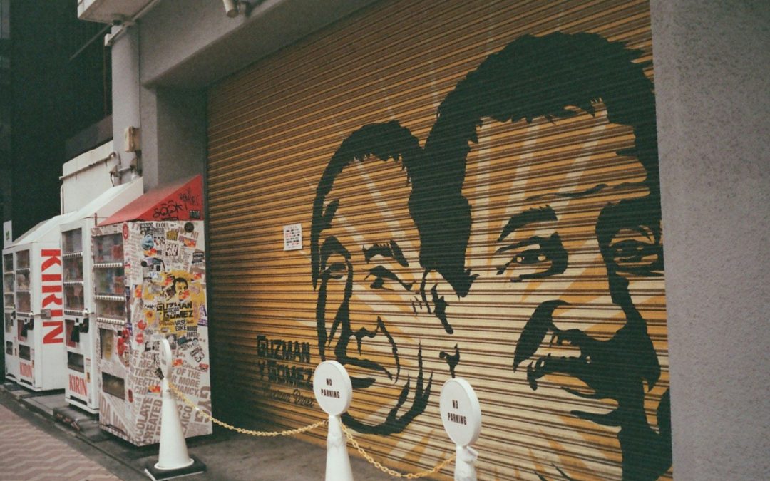 Graffiti art of two faces on a metal shutter